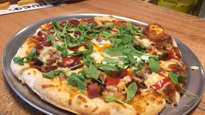 The "Farm Boy" pizza is topped with arugula, roasted red pepper, bacon and an egg.