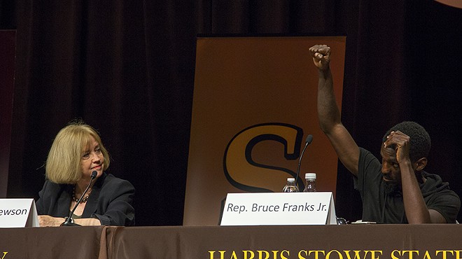 State Rep. Bruce Franks raises his fist during an audience-led protest chant Wednesday night.