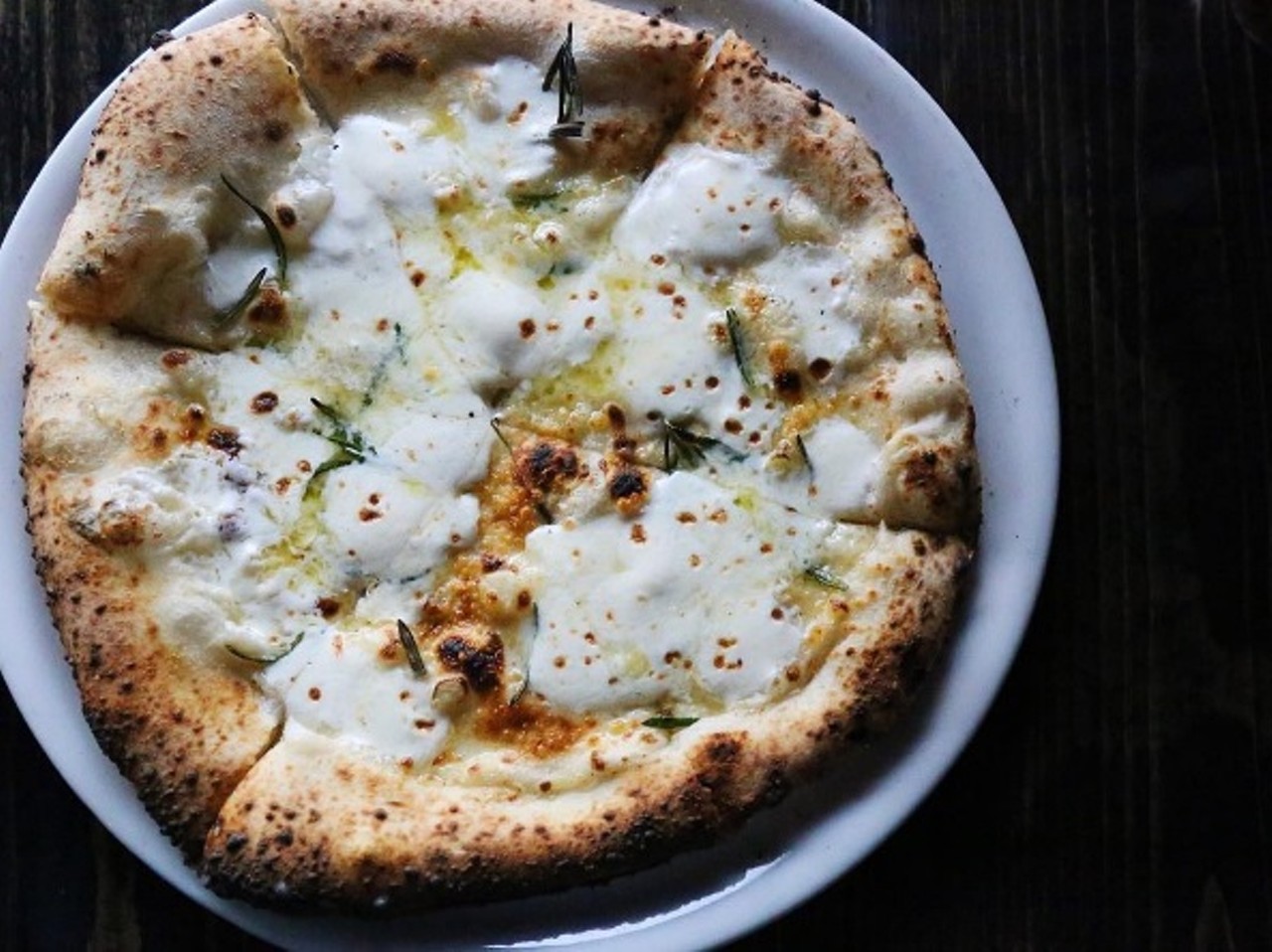 This pizza from Pizzeoli Wood Fired Pizza Napoletana (1928 S. 12th St.,  314-449-1111) includes bechamel sauce, extra virgin olive oil, fresh mozzarella, garlic, rosemary and parmesan. Photo courtesy of Instagram/ feedme_withamanda.