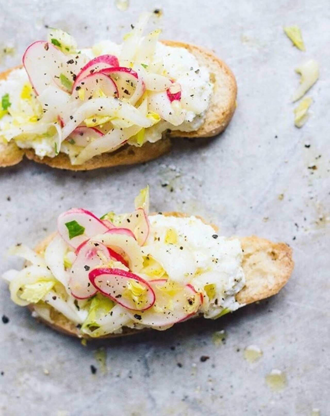 Endive radish salad with lemony vinaigrette on toast. Photo courtesy of Instagram / withfoodandlove.