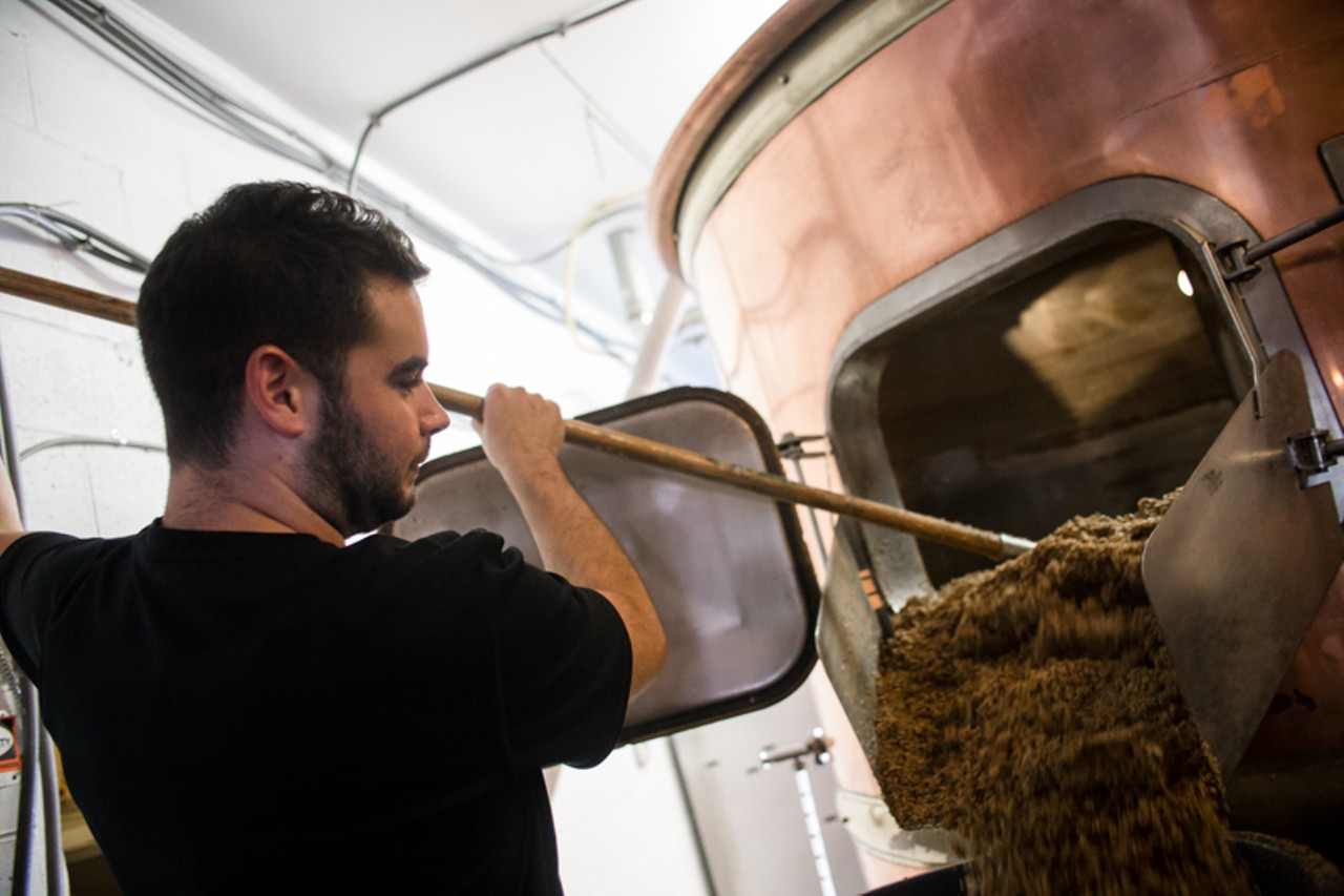 Order up a pecan brown ale along with a beer-friendly menu item, such as pizza, barbecue or a burger. In this photo, brewmaster Ryan Landolt cleans a tank. Photo by Robert Rohe.