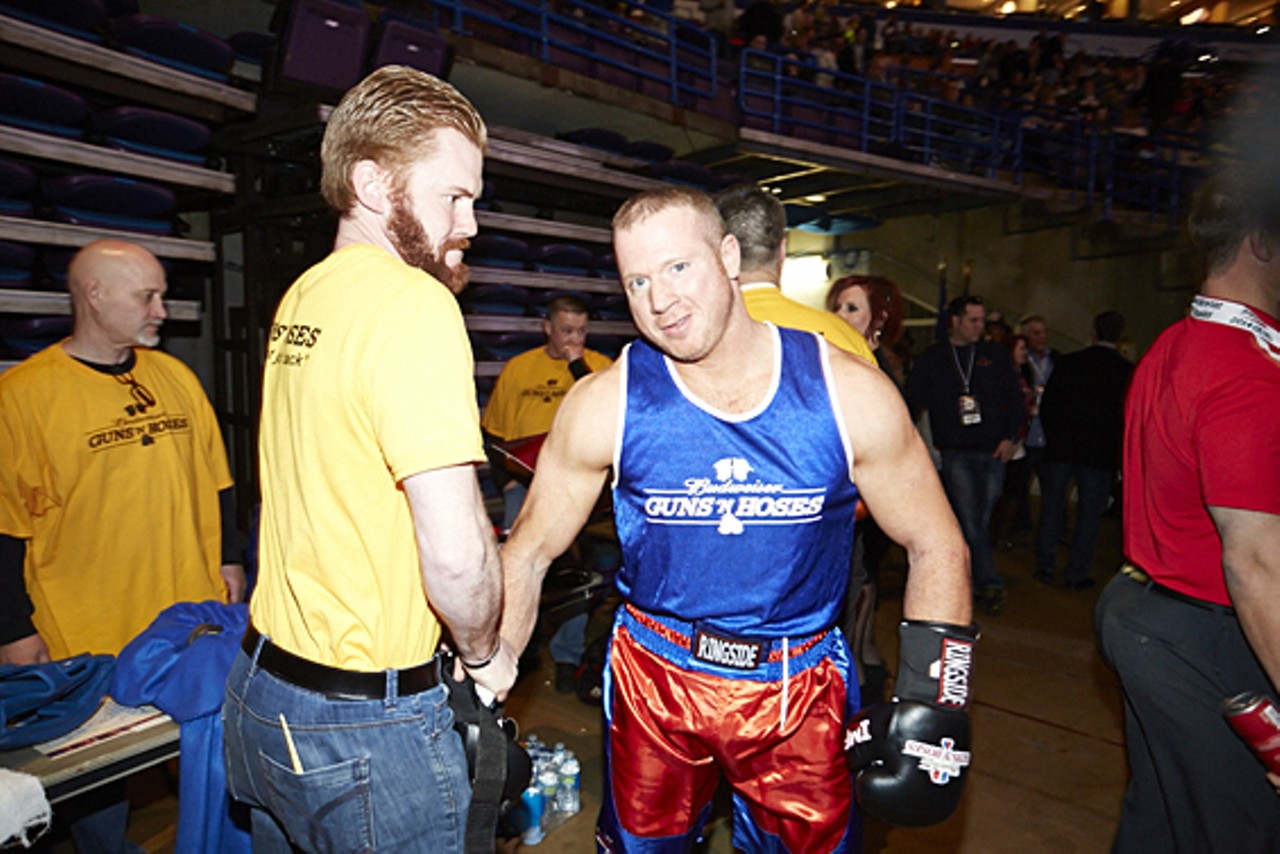 Tim Connors, a Guns 'N Hoses supporter, helps Sean Dougherty into his boxing gloves.