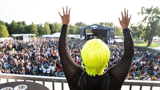 A fan watches Evolution Festival's debut in Forest Park from the VIP area.