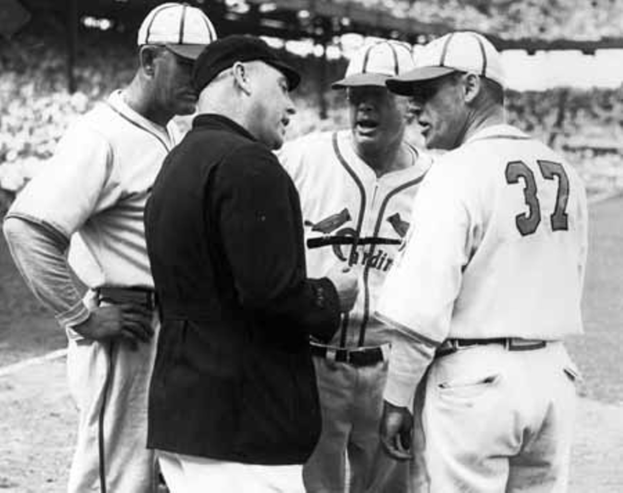 Cardinals players argue with the umpire.