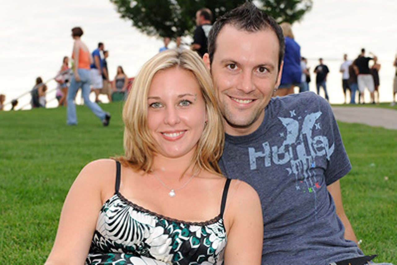 Two fans on the lawn of the Verizon Wireless Amphitheater during Fiction Plane's performance.