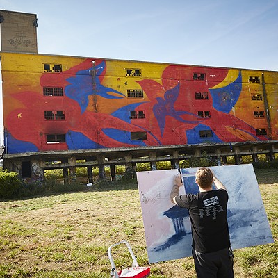 Tyler Harris paints the old depot.