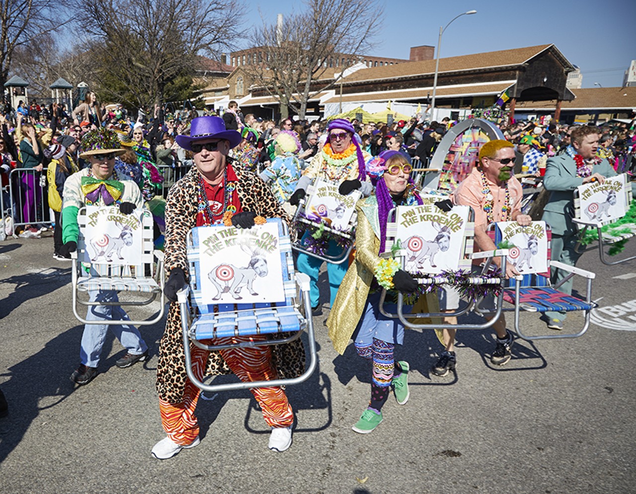 The Gateway Precision Lawn Chair Krewe proudly parading with their "pin the tail on the Kroenke" chairs.