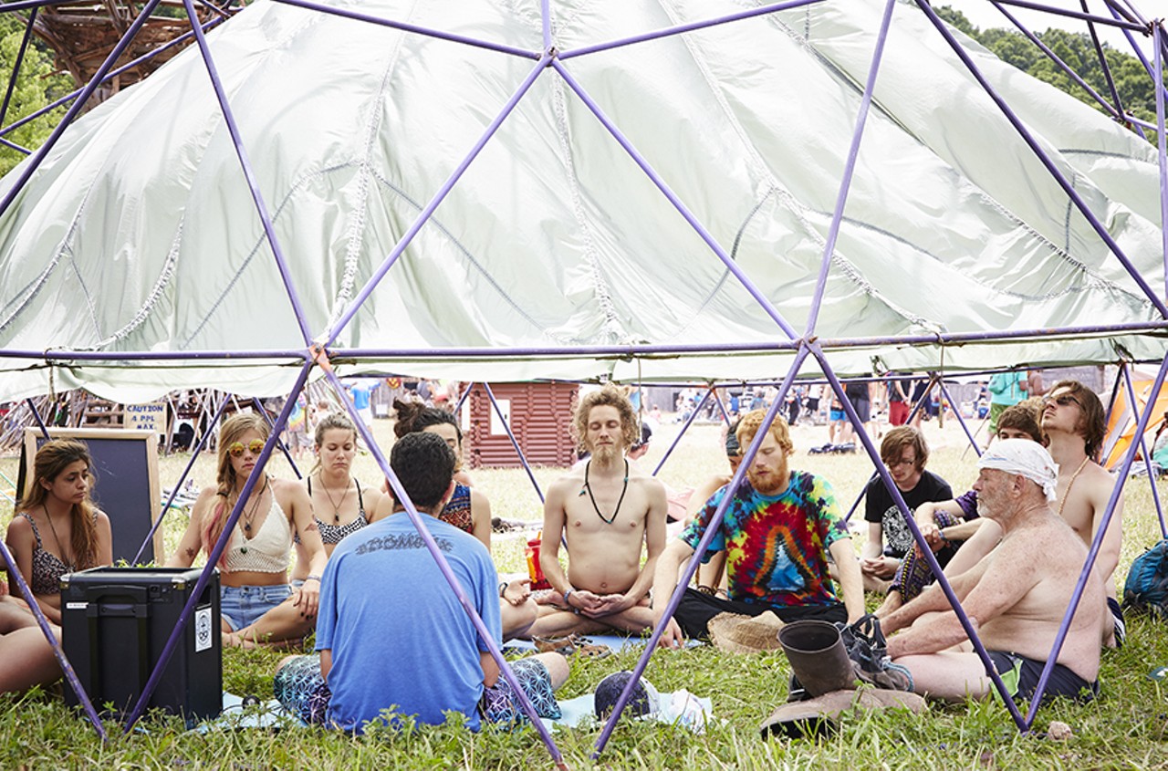 These attendees join in meditation under the dome.