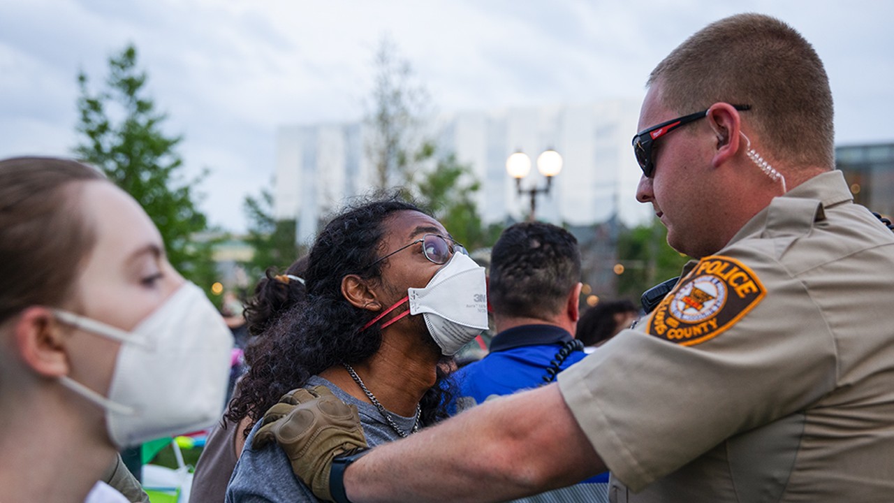 A protestor and a police officer face off on the Wash U campus in St. Louis on Saturday, April 27.