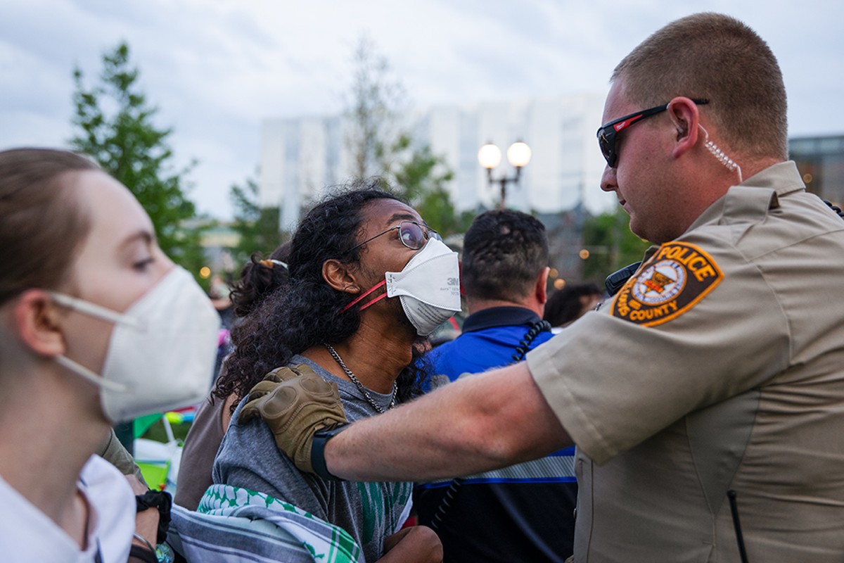 A protestor and a police officer face off on the Wash U campus in St. Louis on Saturday, April 27.