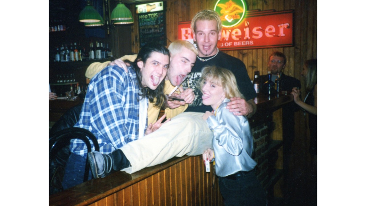 Danny Drabb, Mike Kociela (holding their Riverfron tTimes Slammie Award) and Steve Hunt (sitting on the pony wall by the bar) of New World Spirits, and Brandi Welti. December 3, 1996.