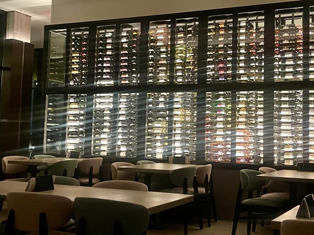 The almost floor-to-ceiling wine wall with the bar’s extensive wine menu of over 70 wines on full display.