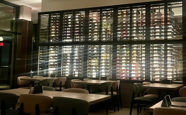 The almost floor-to-ceiling wine wall with the bar’s extensive wine menu of over 70 wines on full display.