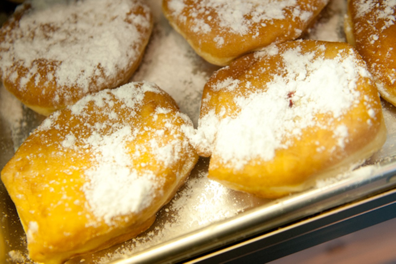 A&nbsp;raspberry-filled donut topped with powdered sugar.