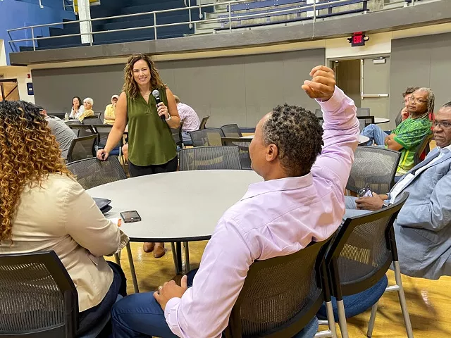 Tiffany (left) and Anwar (middle) Lee at an outreach event in St. Louis on June 22, 2023, where the state’s new chief equity officer, Abigail Vivas (in green), went through all the eligibility requirements for the cannabis microbusiness program.