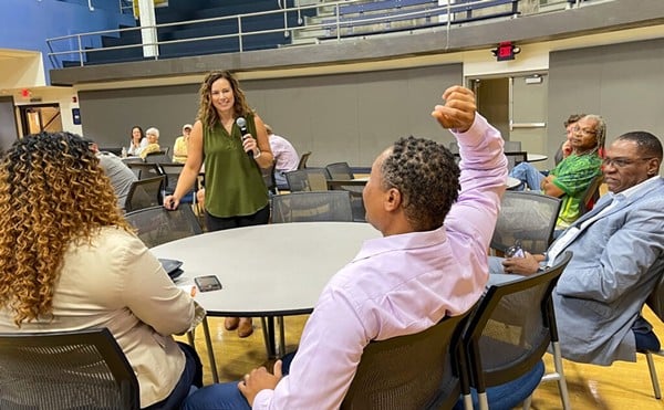 Tiffany (left) and Anwar (middle) Lee at an outreach event in St. Louis on June 22, 2023, where the state’s new chief equity officer, Abigail Vivas (in green), went through all the eligibility requirements for the cannabis microbusiness program.