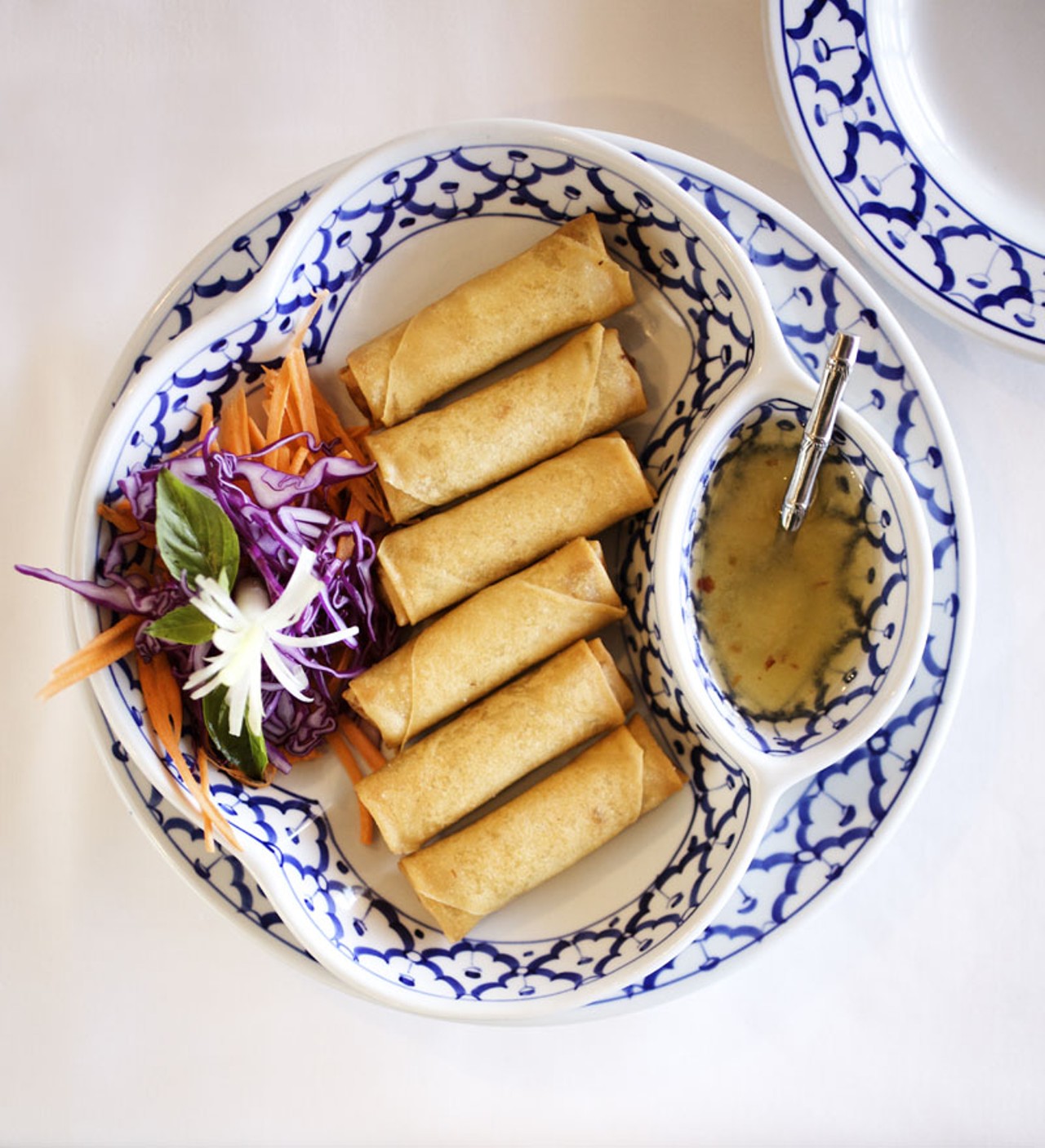 Fried Spring Rolls are prepared with cabbage, carrots, mushrooms, cilantro and glass noodles then wrapped in egg roll wrapper and deep-fried. It is served with sweet and sour sauce.