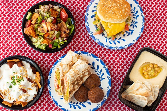 A selection of items from American Falafel: fattoush, kefta burger, eggplant amman, falafel sandwich, falafel bites and hummus.
