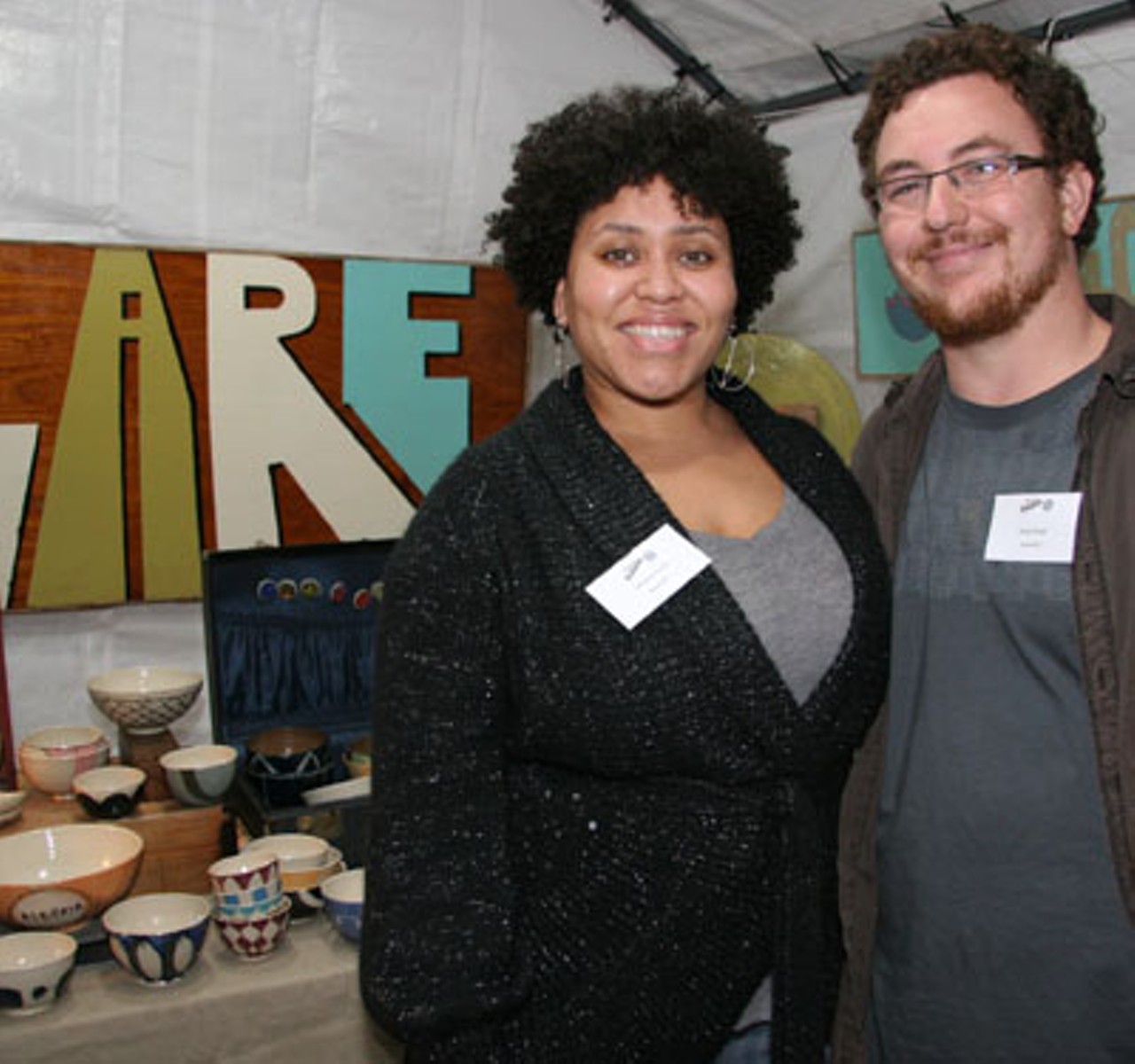 Carmelita Nunez and Daniel Shown stand beside their creations at their joint booth.