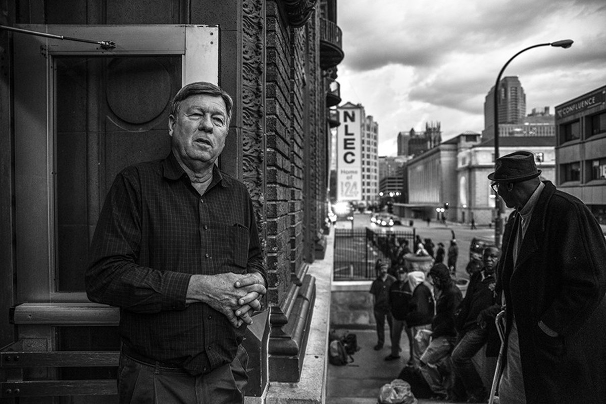 Rev. Larry Rice looks out the front door of the New Life Evangelistic Center as homeless men wait in line for potential beds for the night on November 14.