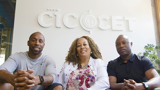REAL Cannabis Co.’s Justin Gage, left, and Cheryl Watkins-Moore, center, with the company’s founder and president Derek Mays.