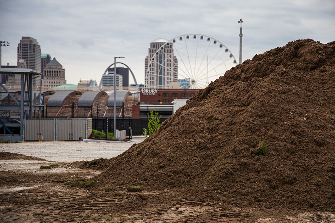 Piles of dirt and grass sit in a parking lot near Citypark. The old field was transported to St. Louis Composting to be reused.