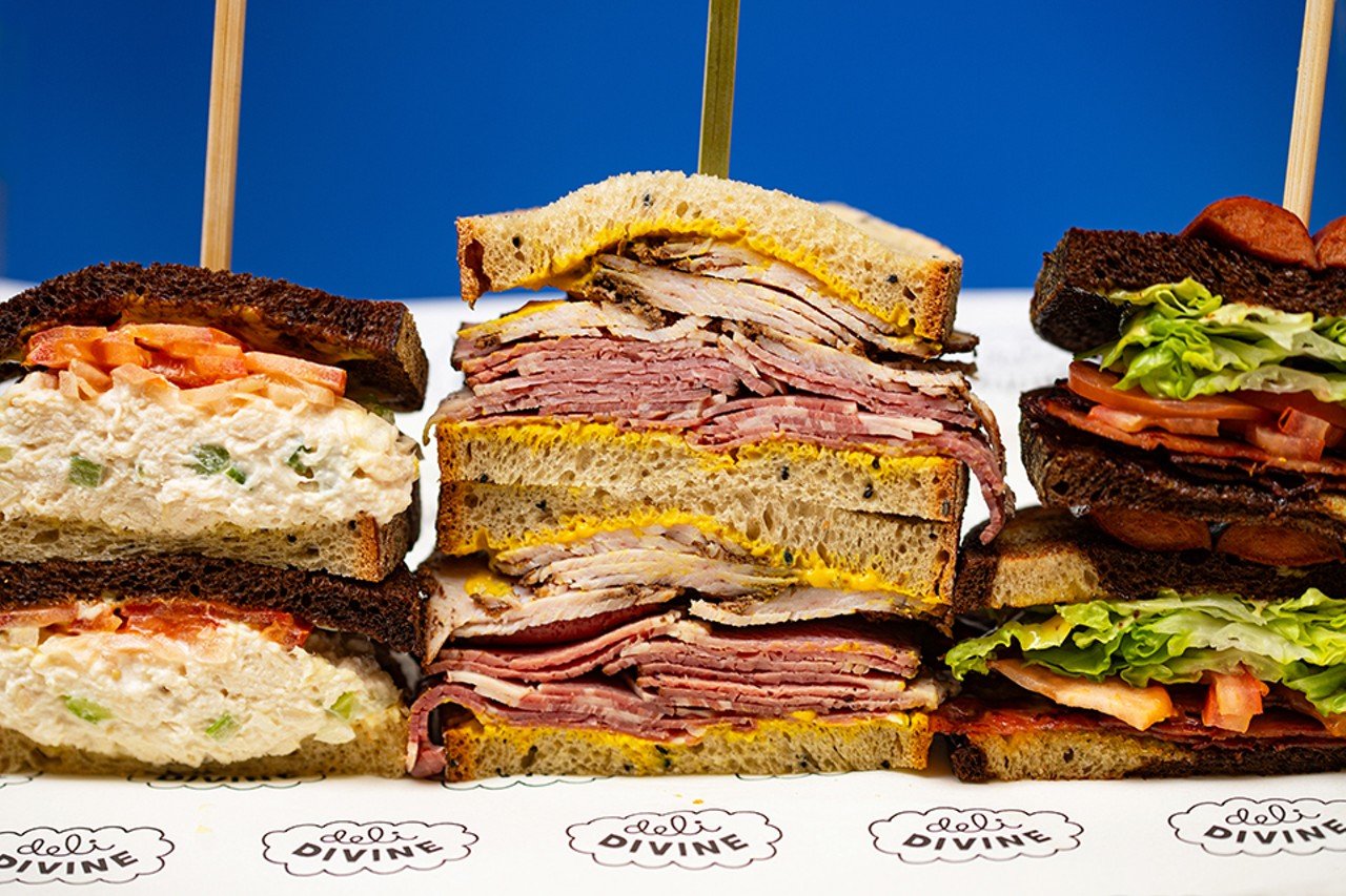 A selection of items from Deli Divine: chicken salad sandwich, smoked turkey and pastrami sandwich, and Manek sandwich.