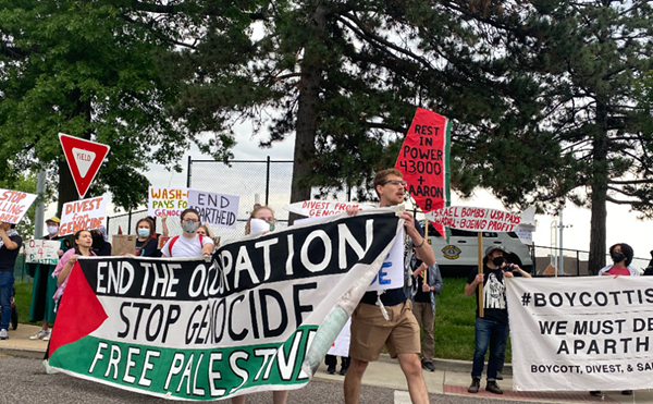 Pro-Palestine protestors stand outside of Washington University's commencement ceremony on May 13, 2024.