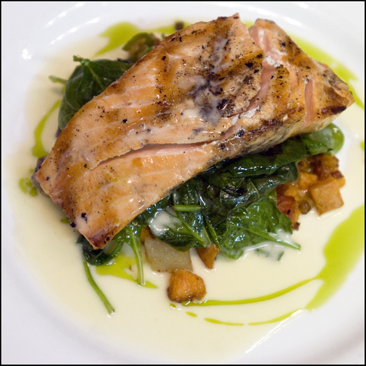 Grilled Atlantic Salmon served with potato medley, sauteed leeks, white wine lemon beurre blanc and  chive oil. Read "The Year of the Herb: Balaban's re-rebirth as Herbie's Vintage 72 makes the Central West End whole again," by Ian Froeb.