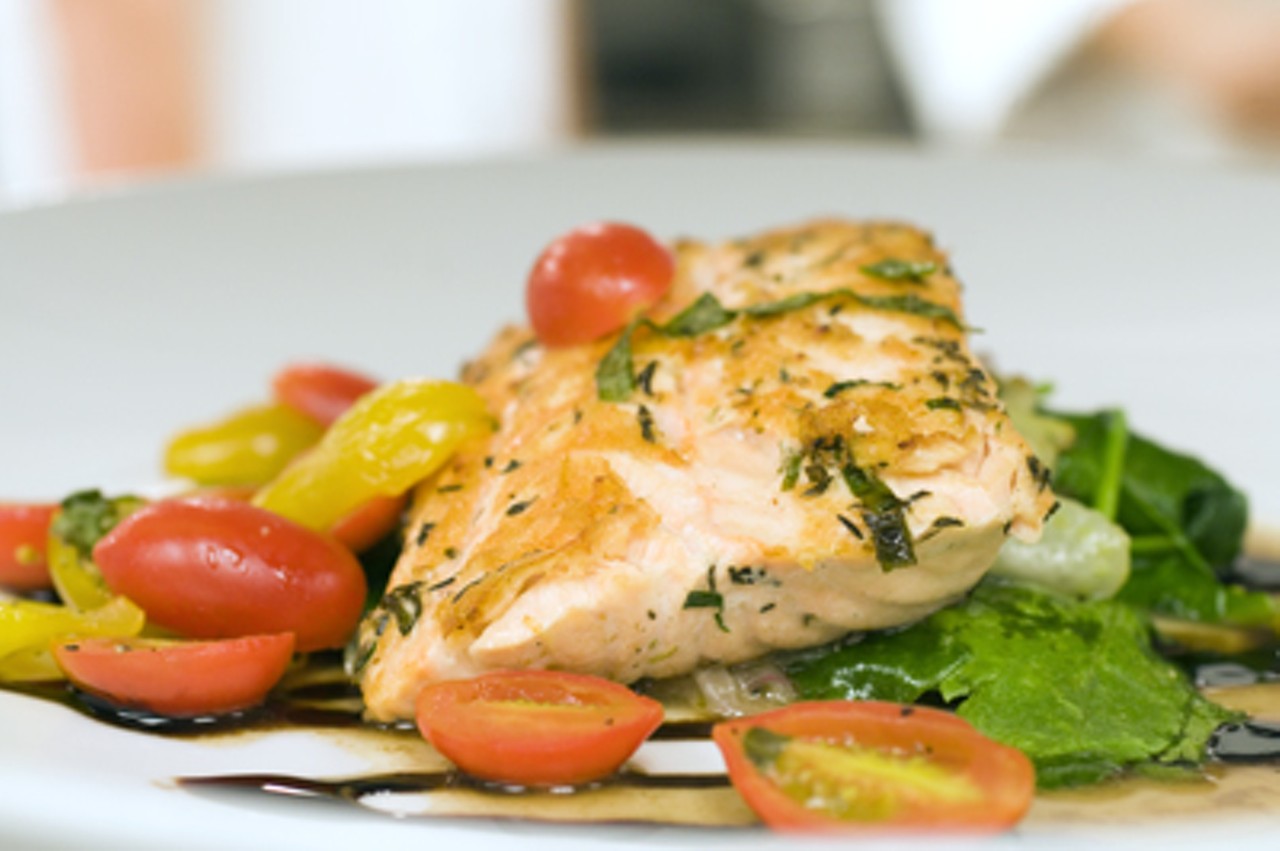 Grilled Atlantic salmon with tomatoes and wilted spinach, that day's chef&rsquo;s special.