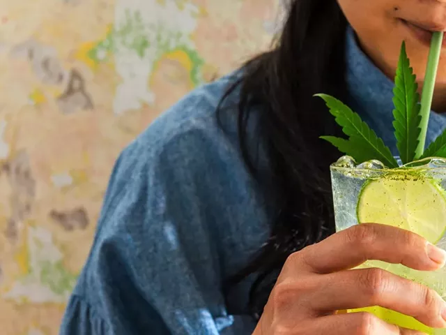 Young Woman drinking a THC-infused drink with a straw, the image features a cannabis leaf.