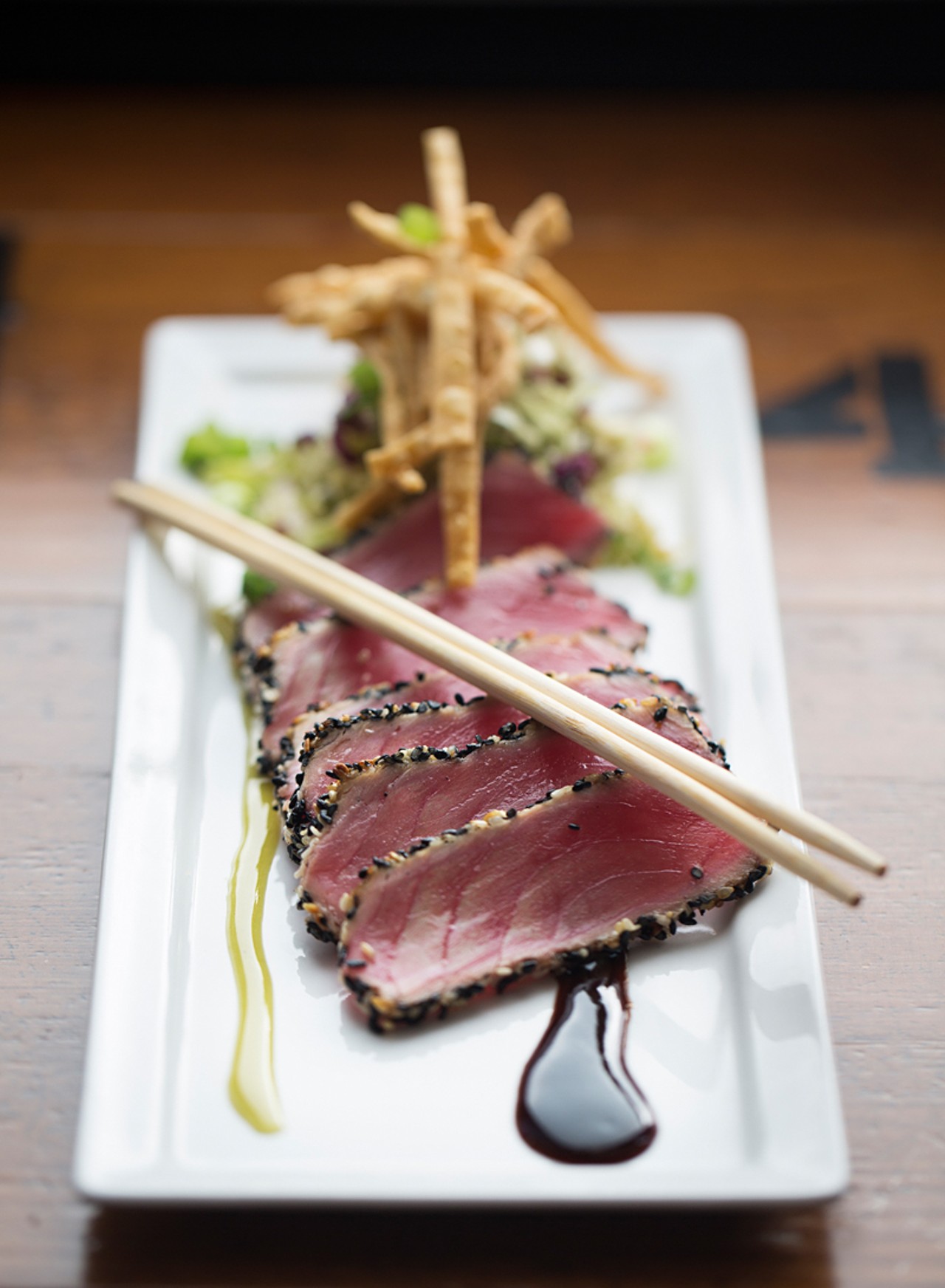 The sesame-encrusted tuna is served with a soy-ginger reduction, honey-wasabi sauce and crispy wontons.