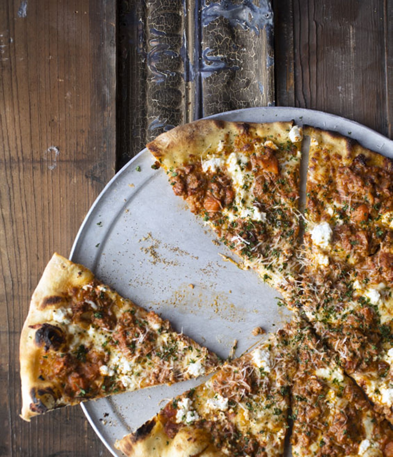 The "Bolo" is a New York-style pizza with an olive-oil crust, herbs, mozzarella, ricotta, savory pork and beef bolognese, fresh-grated Parmesan and parsley.
