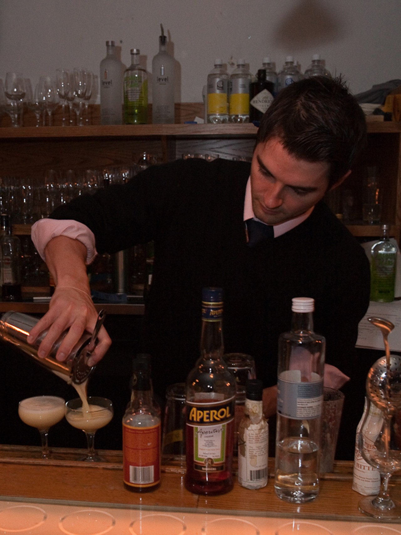 TJ Vytlacil of Flamingo Bowl mixes two glasses of his signature drink of the evening, the Salvia Ovo.