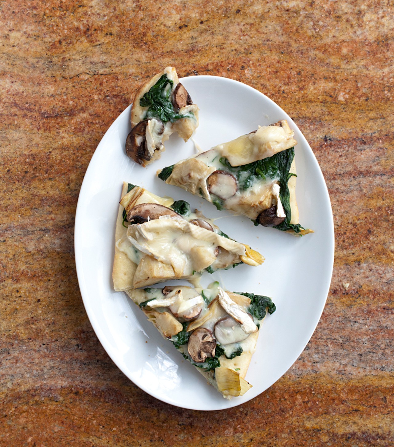 Roasted-artichoke flatbread with portabella mushrooms, spinach and Camembert cheese.