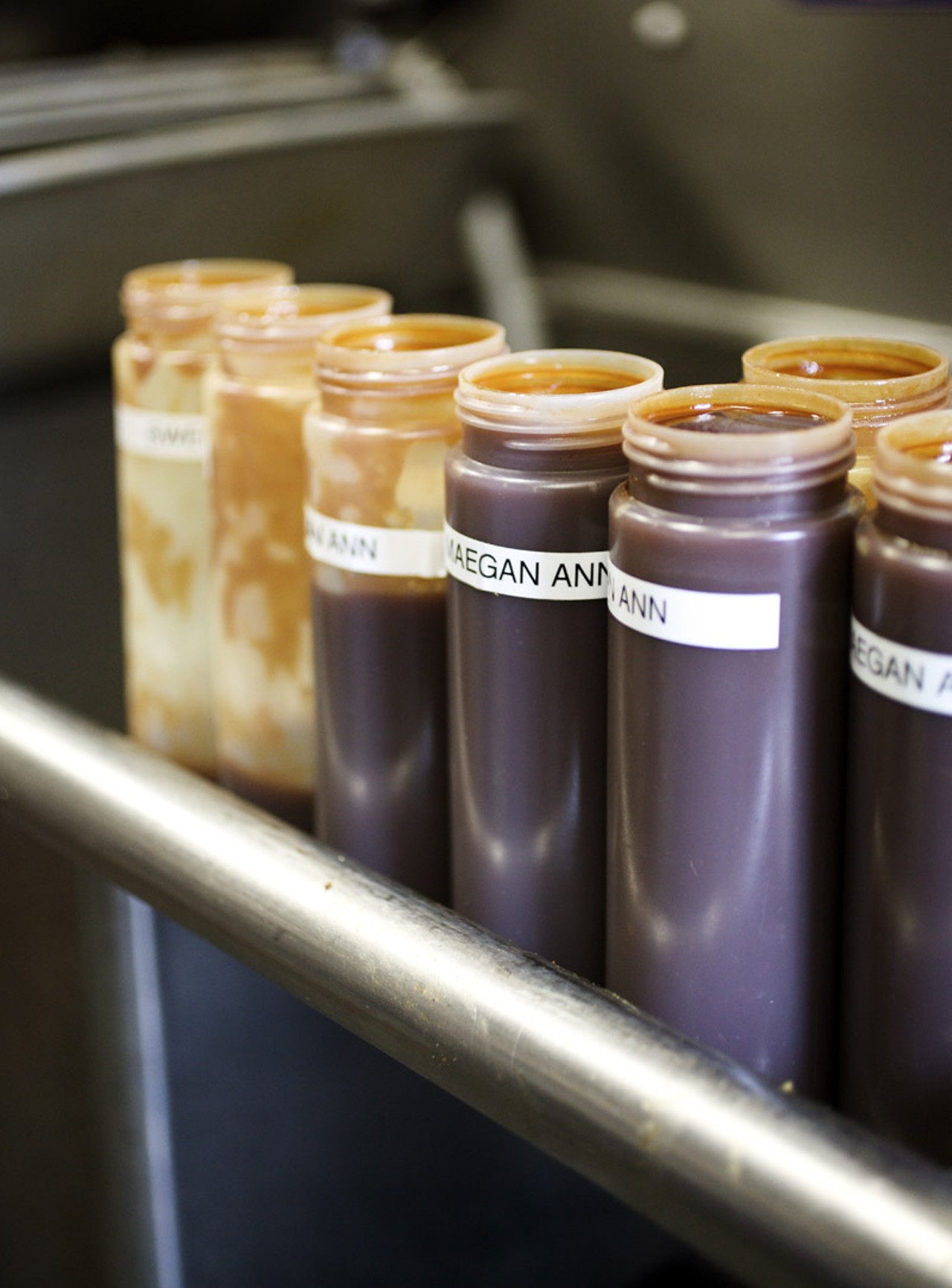 Sauces need to often be refilled on the tables of Bogart's smokehouse. Four varieties are available, Voodoo Sauce, Sweet Maegan Ann, Pineapple Express and Mad Maddie's Vinegar.