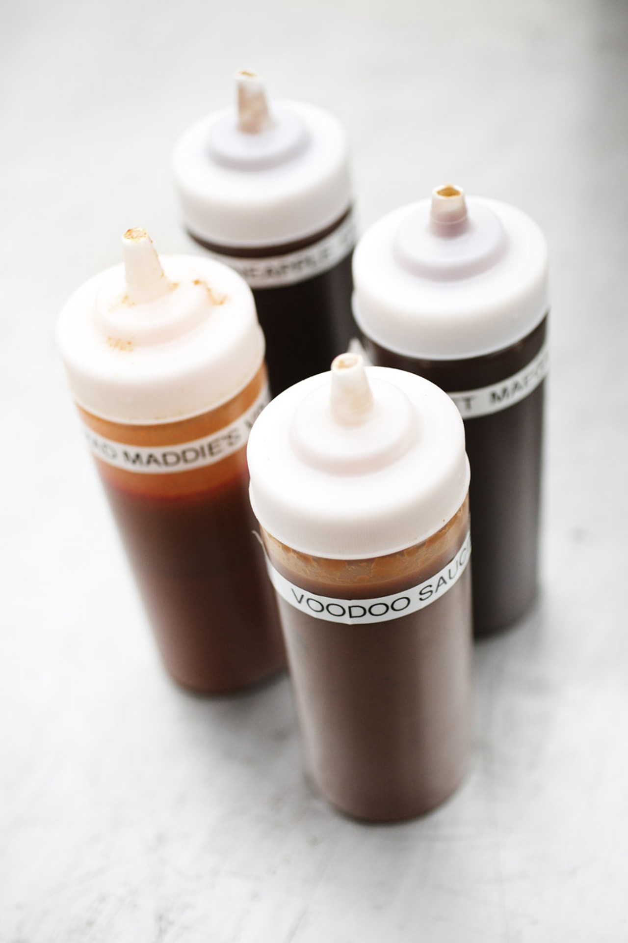 Sauces need to often be refilled on the tables of Bogart's smokehouse. Four varieties are available, Voodoo Sauce, Sweet Maegan Ann, Pineapple Express and Mad Maddie's Vinegar.