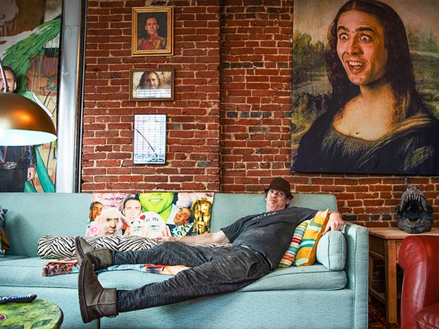 Homeowner Jack Saline relaxes on his Nic Cage-themed couch.