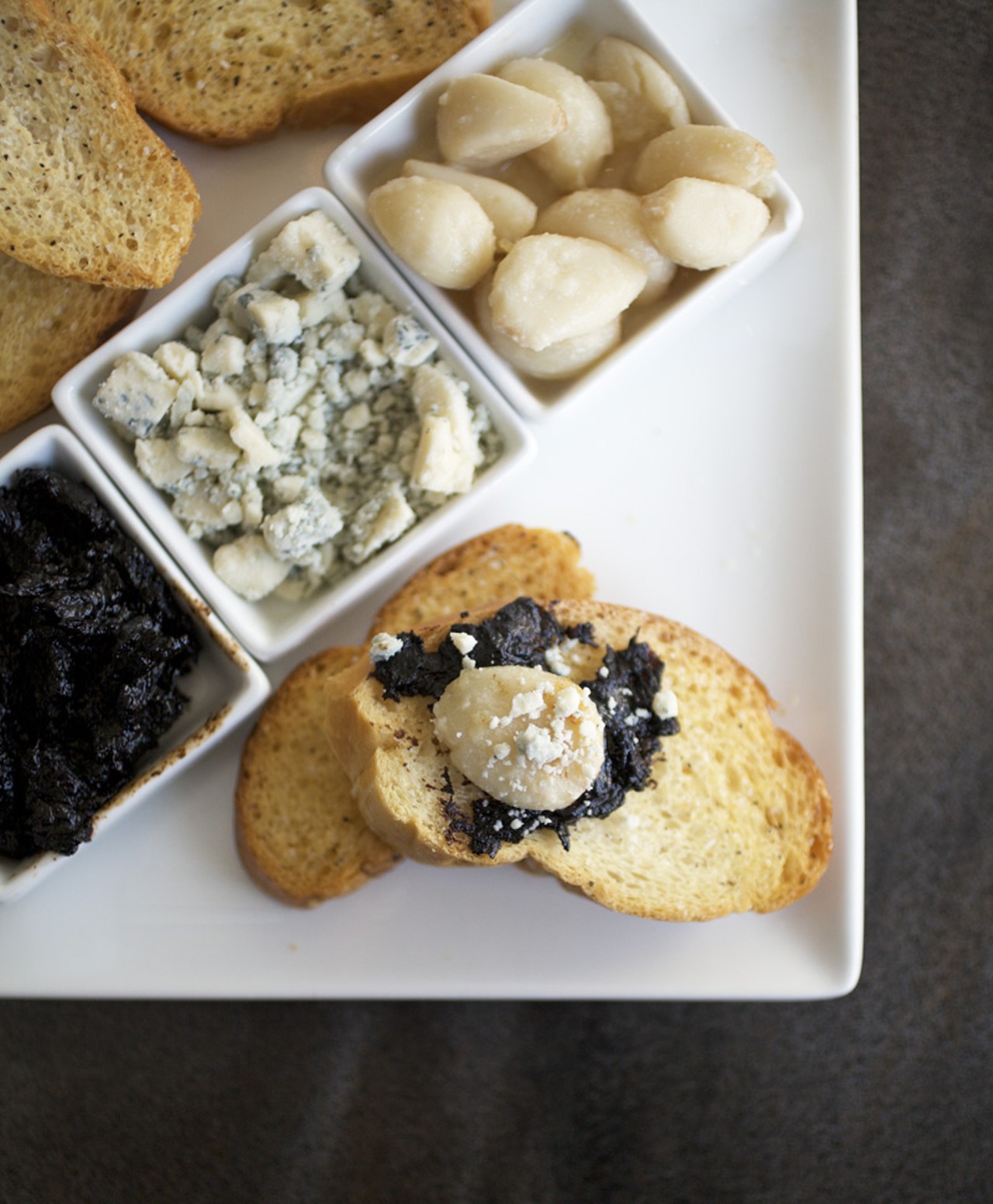 Ajo Asado - warm roasted garlic with house made balsamic jam, cabrales Spanish blue cheese, crostini and lavash.