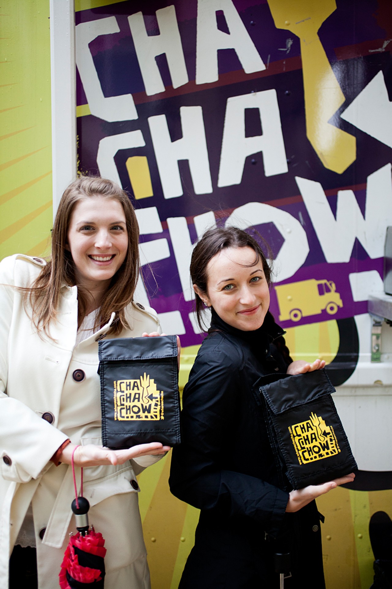 Regulars, Beth Babb and Julia Meisler showing off their Cha Cha Chow sacks that the food truck was giving away to celebrate their one-year anniversary.