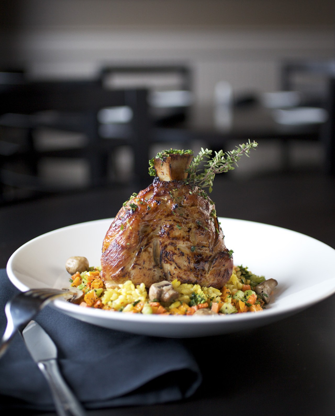 The Pork Osso Buco is a slow roasted pork shank with risotto Milanese and roasted vegetables topped with natural au jus.