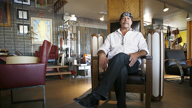 Rick Orr relaxes among mid-century treasures, some from his own stash, at Red Modern Furniture in Phoenix.