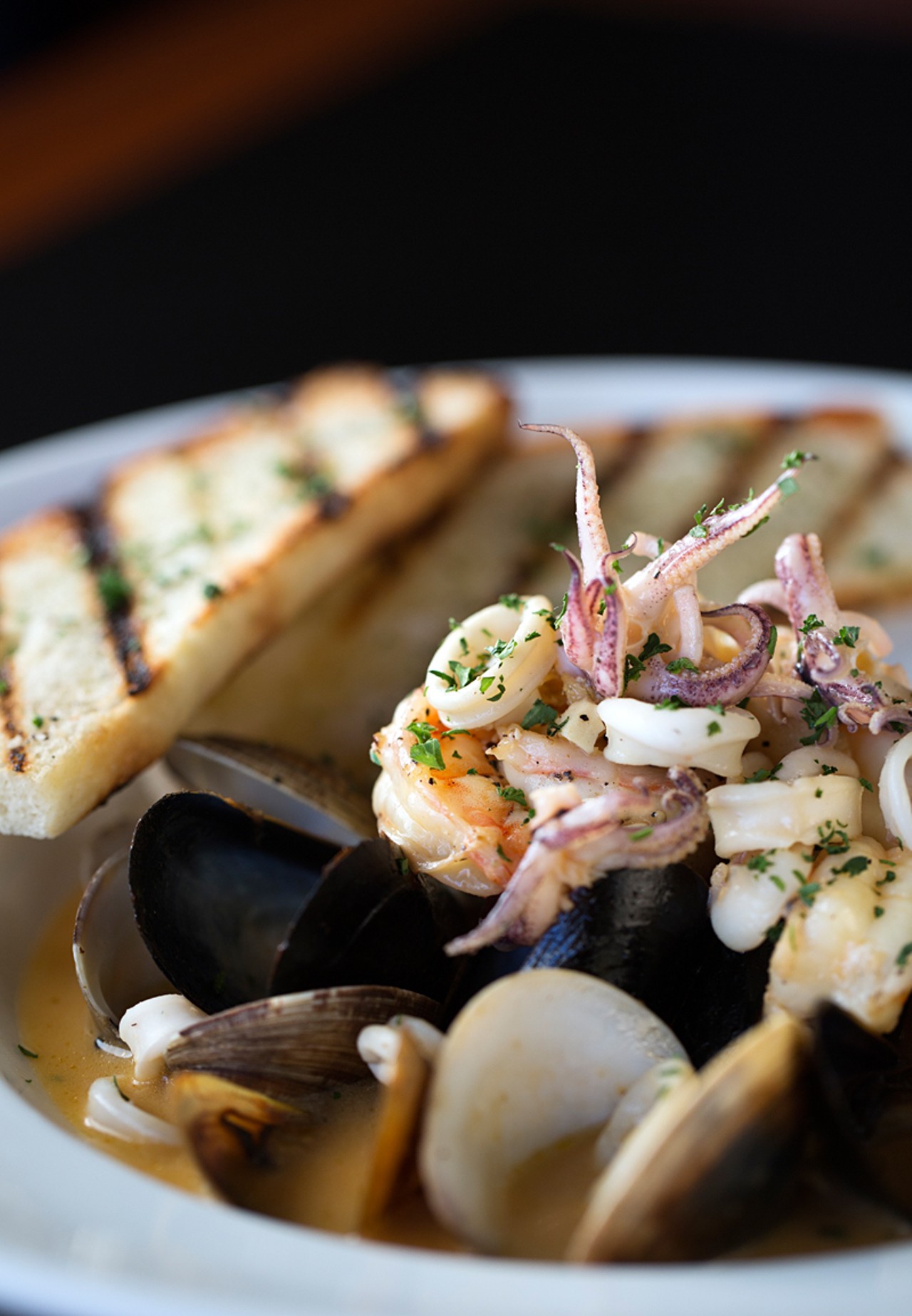 The seafood stew is made with mussels, clams, fish, shrimp and calamari in a tomato-saffron broth.