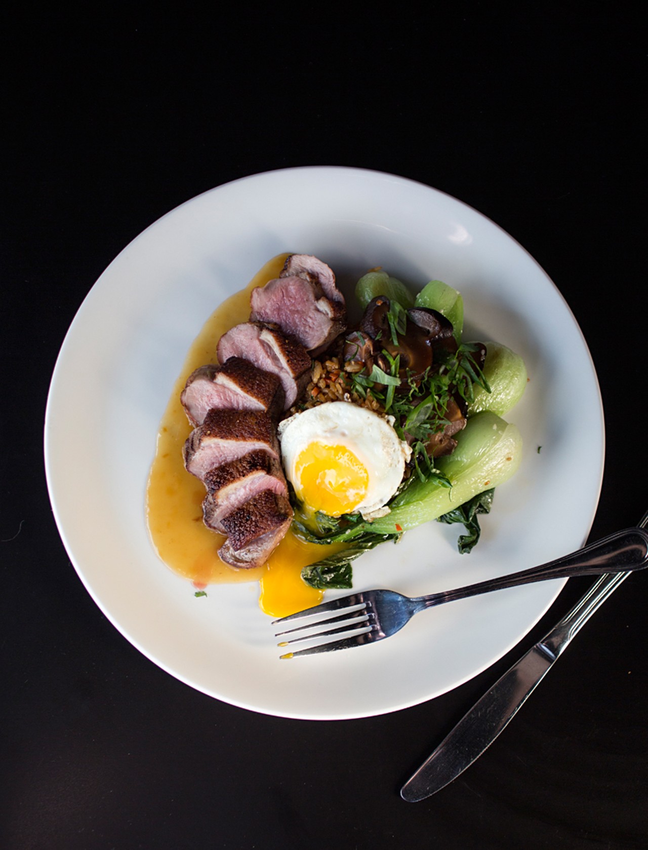 Duck breast comes with pickled shiitake mushrooms and bok choy.