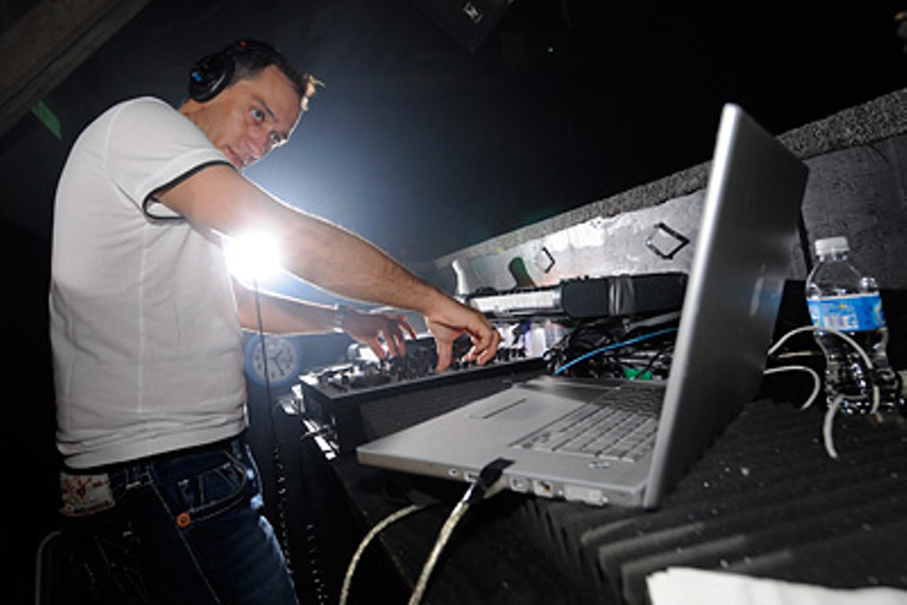 DJ Paul van Dyk perform makes precise adjustments during his set while monitoring his laptop.
