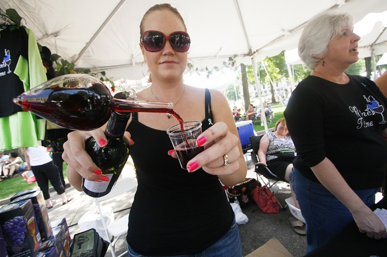 A woman pours out a sample of red wine using a "one dose" wine decanter, which aerates the wine to releases more aromatic compounds.