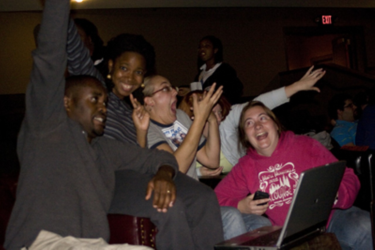 Obama supporters at the Moolah Theatre react to the polls results.