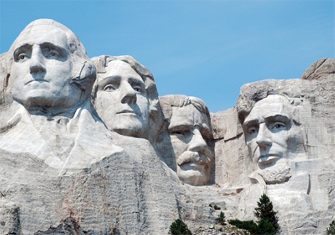 Teddy Roosevelt, third from left, has his face chiseled out of the side of Mount Rushmore, mustache included.