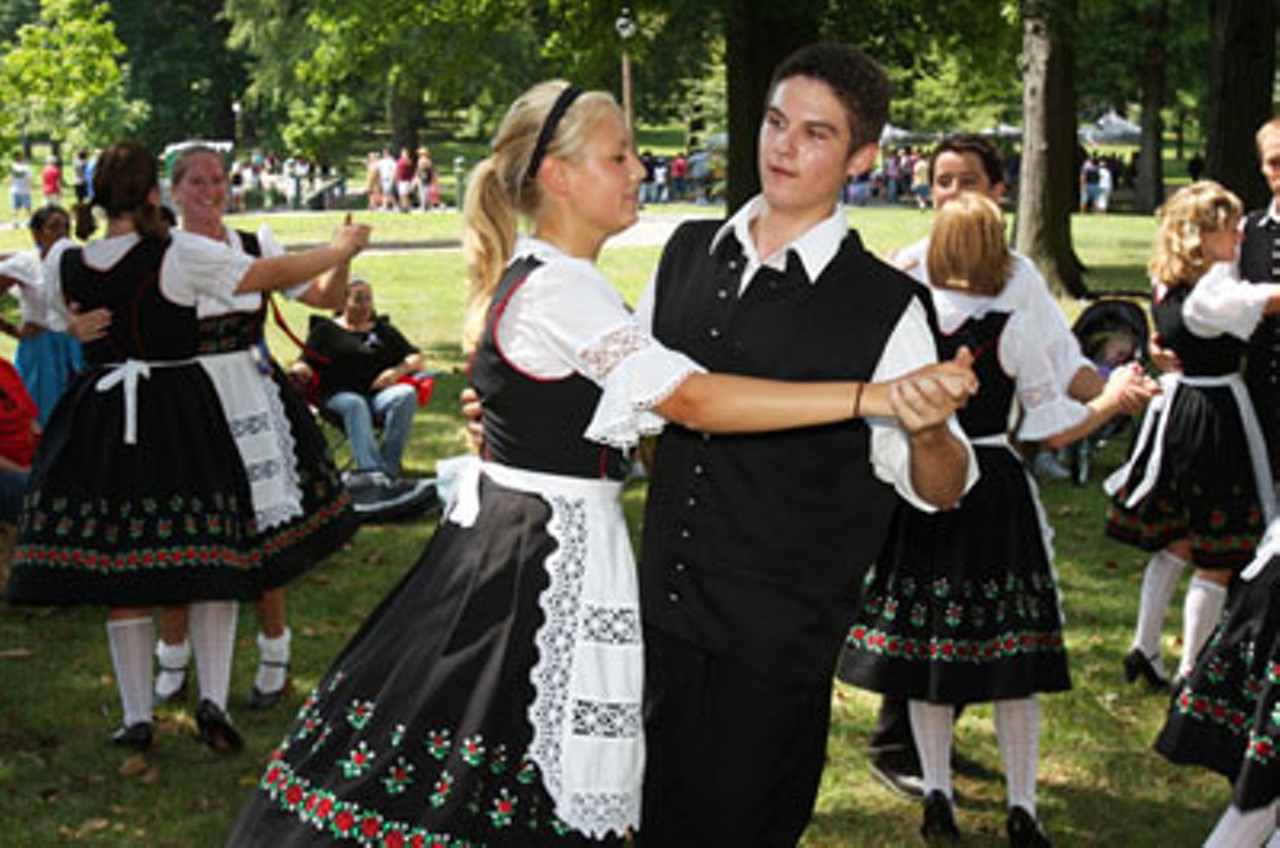 Elise Wagener and Gavin McMullen perform German dancing in the Village Green area of the park Saturday afternoon.