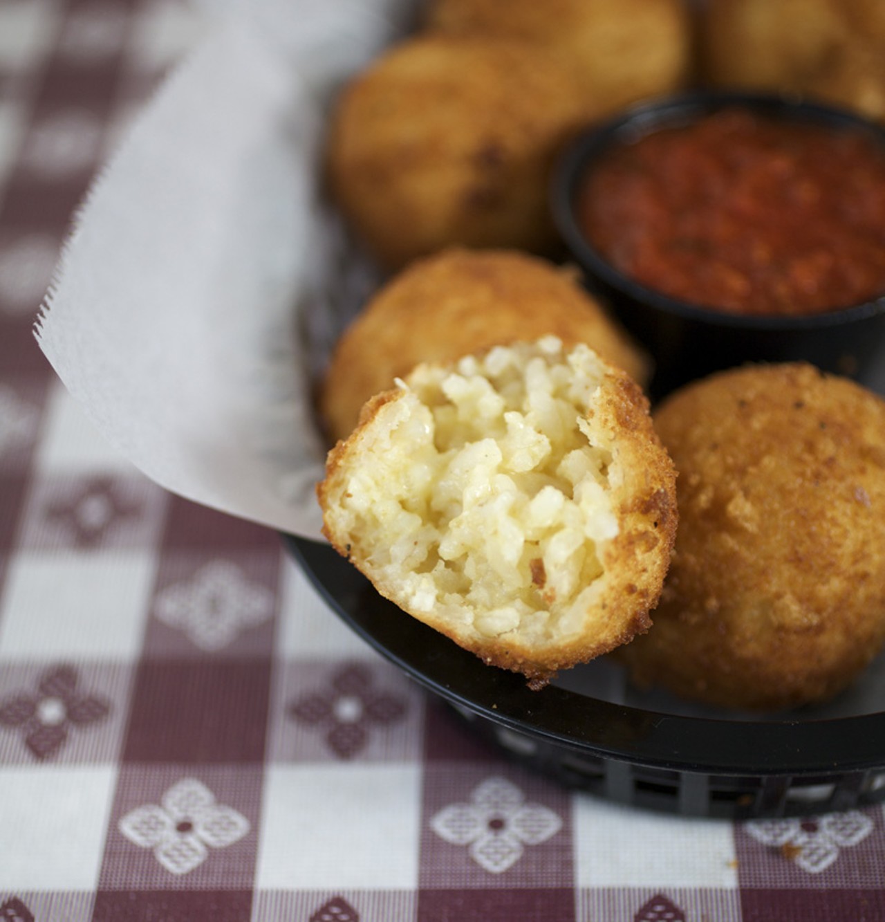 The Arancini appetizer is a Filomena's house specialty. They are housemade risotto croquettes, flash fried with a melted cheese center and served with marinara sauce.